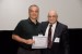 Dr. Nagib Callaos, General Chair, giving Prof. Panayotis S. Tremante M. the best paper award certificate of the session "Sistémica y Aplicaciones de Informática y Cibernética ." The title of the awarded paper is "Ajuste de las Funciones de Pertenencia de Entrada de un Sistema de Control con Lógica Difusa de un Péndulo Invertido mediante el Método de Optimización del Patrón de Búsqueda."